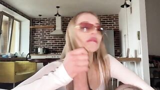 A beautiful whore wearing glasses gets a cumshot right on her face