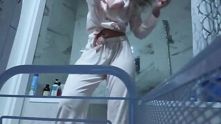 A petite girl rubs her wet pussy in the bathroom, no one sees
