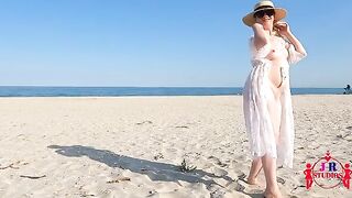 A couple poses naked and makes love for the first time on a public beach