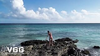 A petite and sexy girl gets naked on a sunny beach