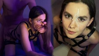 A hot brunette in a harness captures the moment of intense passion on her face