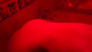 A blonde is having fun with a big toy in the bathroom