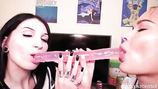 Lesbian beauties fuck each other with a double-ended dildo, showcasing their juicy pussies