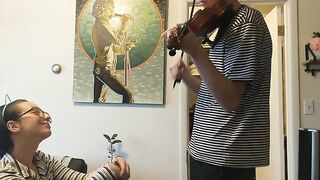 A couple was interrupted while the girl tried to practice violin