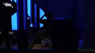 A girl is trying on clothes in the fitting room, while a guy is pressing her against the glass