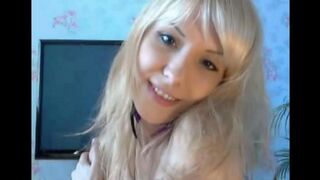 Blonde caresses her pussy with fingers in a sensual solo act