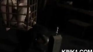 A slave in a cage is at the mercy of orders from a mistress