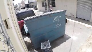 A girl was photographed having sex behind a garbage tank