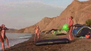 A man and woman play badminton naked on the nude beach