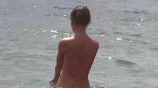 A group of people enjoy a day at the nudist beach