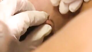 A nice woman plays with her new clitoris piercing