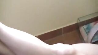 A naked girl with big natural tits is smoking