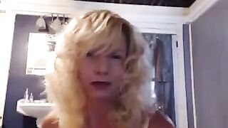 A mature woman caresses herself in the bathroom with a toy for excitement