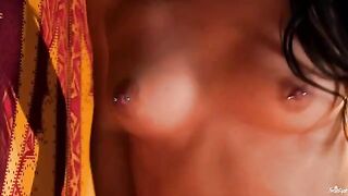 A girl with a nipple piercing plays with her fingers