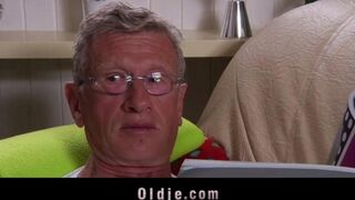 An aged guy is having fun with a hot young blonde on the couch