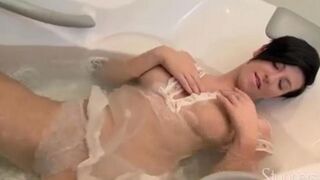 A lonely brunette caresses herself in the shower stream