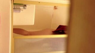 A girl washed herself in the shower, not suspecting a hidden camera