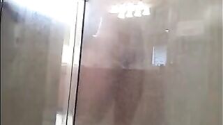 A man washes himself under a hidden camera in the shower