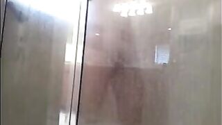 A man washes himself under a hidden camera in the shower