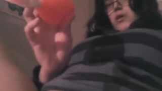 A girl caresses her clit with a vibrator on the bed