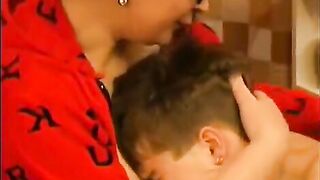 A hot woman in glasses is having fun with a young guy