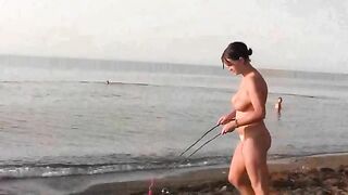 A naked girl is having fun on the beach, exposing her body in public