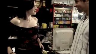 The guy is having sex with the charming saleswoman right at her workplace