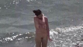 A couple of nudists have fun on the beautiful beach
