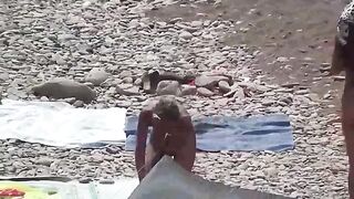 A couple of nudists have fun on the beautiful beach