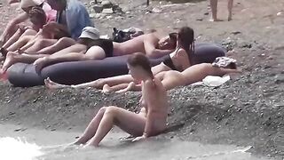 A couple of nudists have fun on the beautiful beach