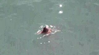 A pair of free-spirited naked lovers enjoy each other at sea