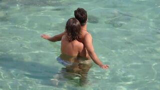 A girl plays with a guy’s dick underwater in the sea
