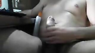 Guy sits in front of the computer and masturbates his dick with jerking
