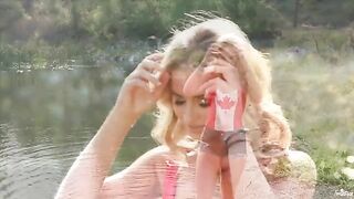A tender moment of self-pleasure by a blond-haired lake
