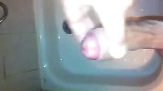 The kid masturbates his dick in the shower with his hand