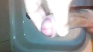 The kid masturbates his dick in the shower with his hand