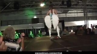 A girl is learning to striptease on a pole with a great coach