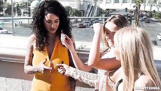 Two sexy girls are having fun on the strip, playing with each other