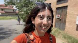 A girl is walking on the street with her mouth open