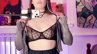 An alternative girl caressed herself through her panties, showcasing her allure in a mirror